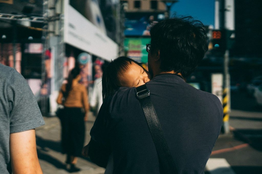 man carrying child